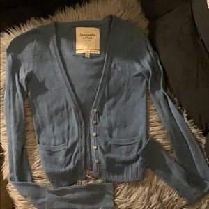 Cardigan sweater with front buttons and pockets.